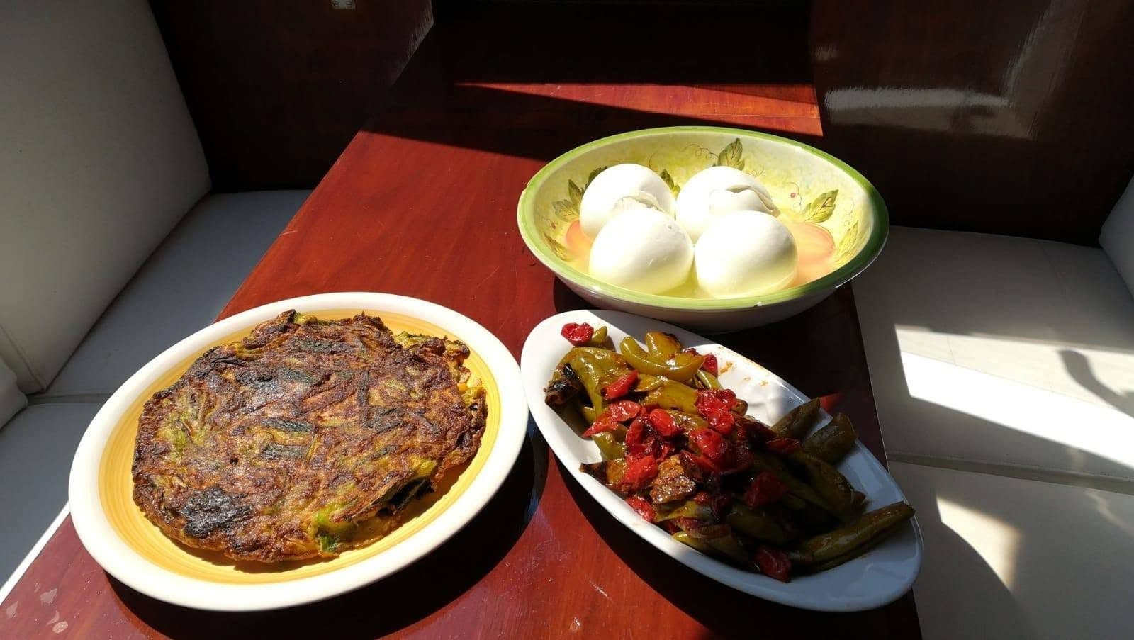 Home-cooked dishes on board: frittata, mozzarella and peppers on the cockpit table